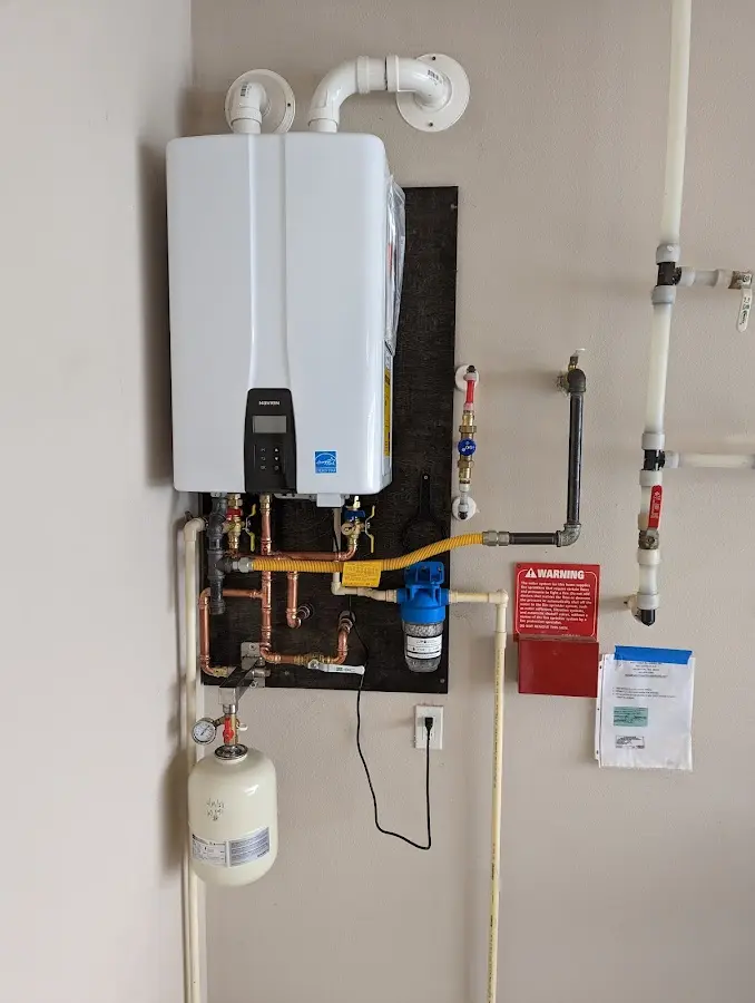 Professional plumber installing copper piping in a Chariton home